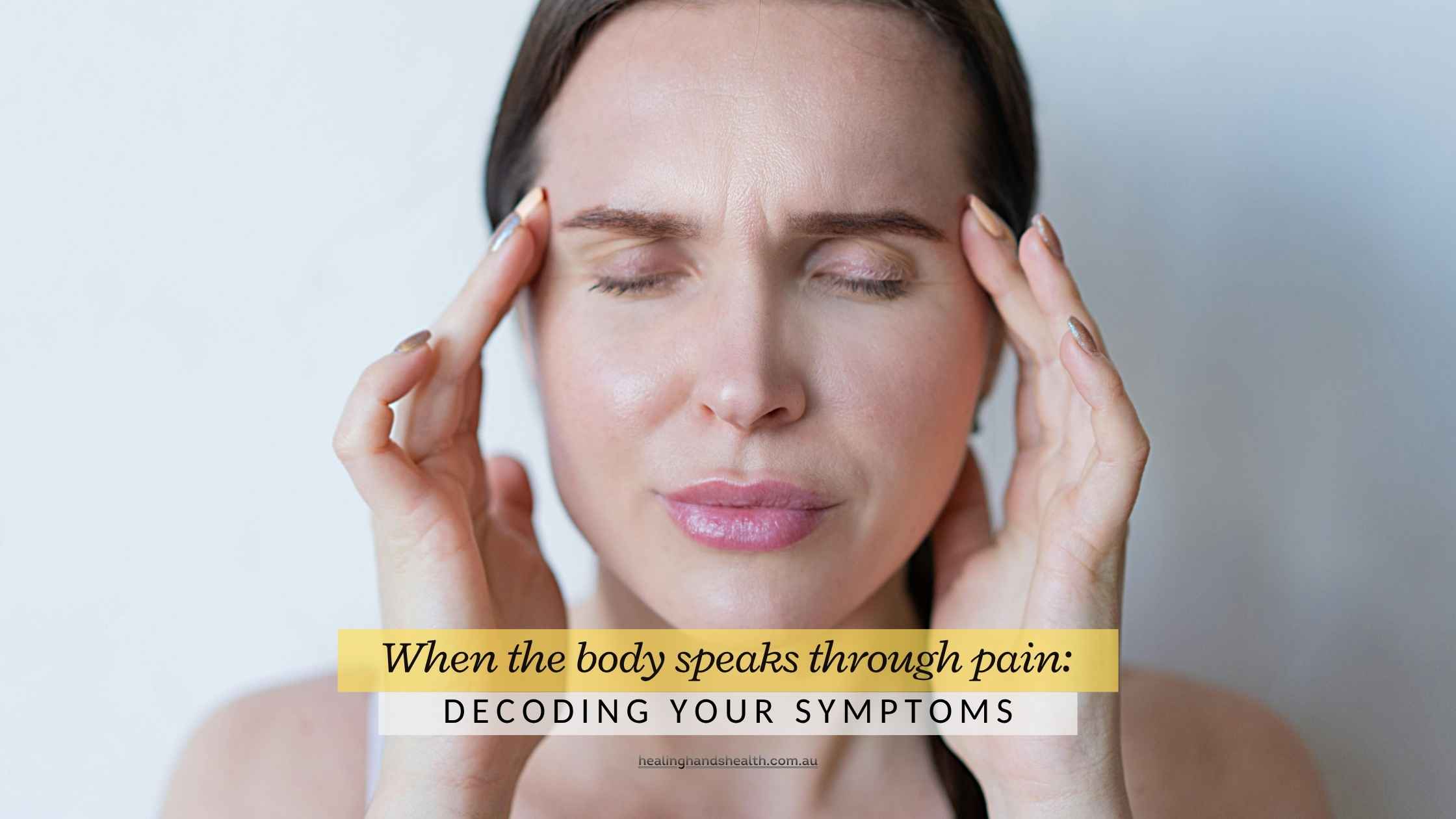 Person holding their head in discomfort, representing the emotional roots of physical pain